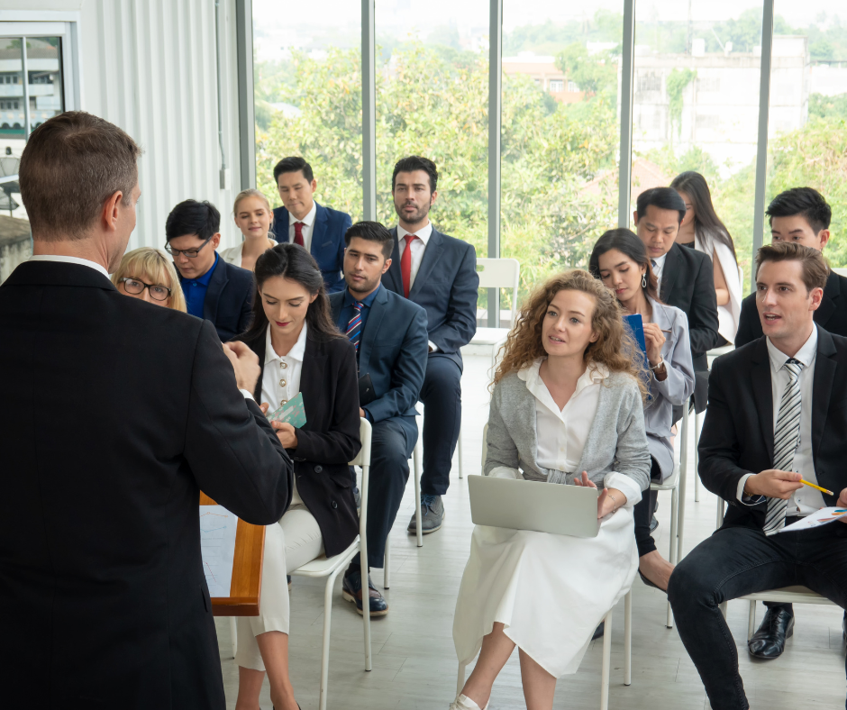 A group of employees actively listening to each other in a meeting