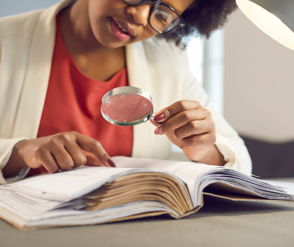 A person reading a code of conduct document with a magnifying glass