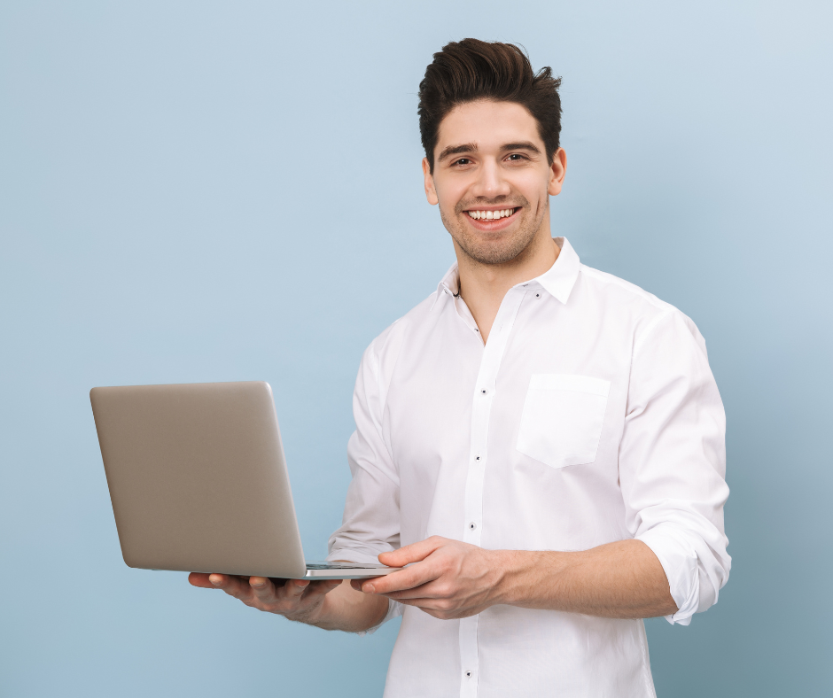 A person smiling and holding a laptop with a welcome aboard email open