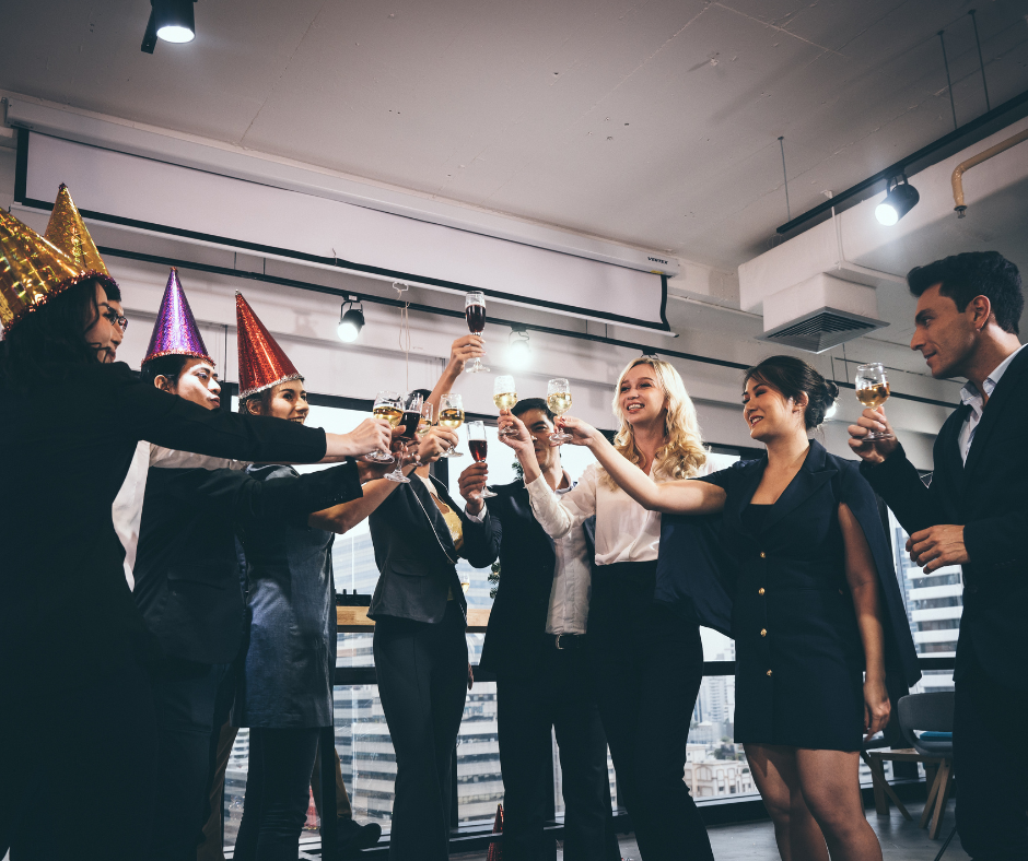 Group of people celebrating success in a workplace