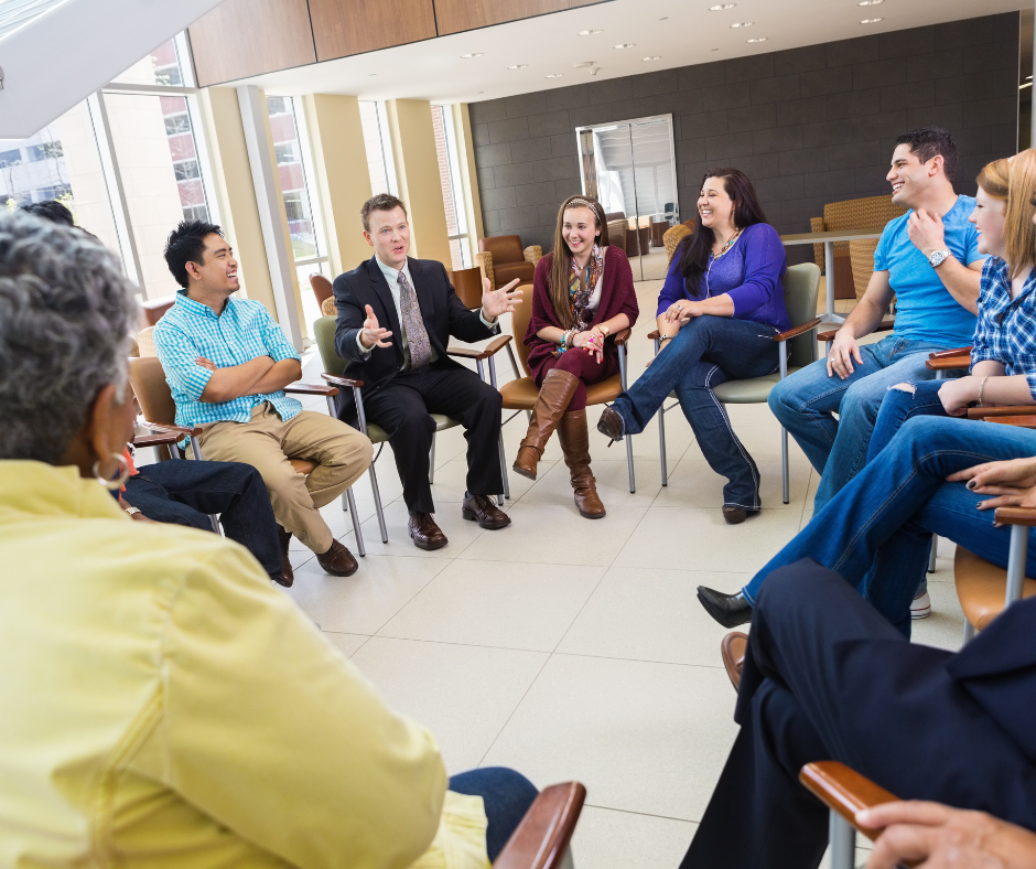 Group of people in a meeting discussing welcome message