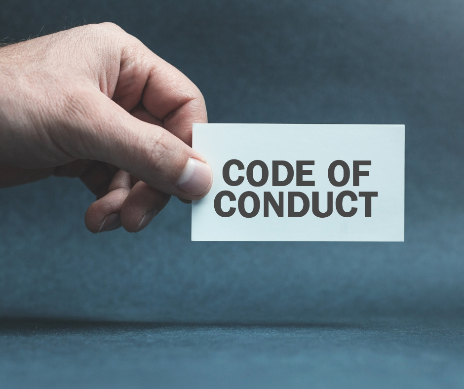 Photo of a person reading a code of conduct document